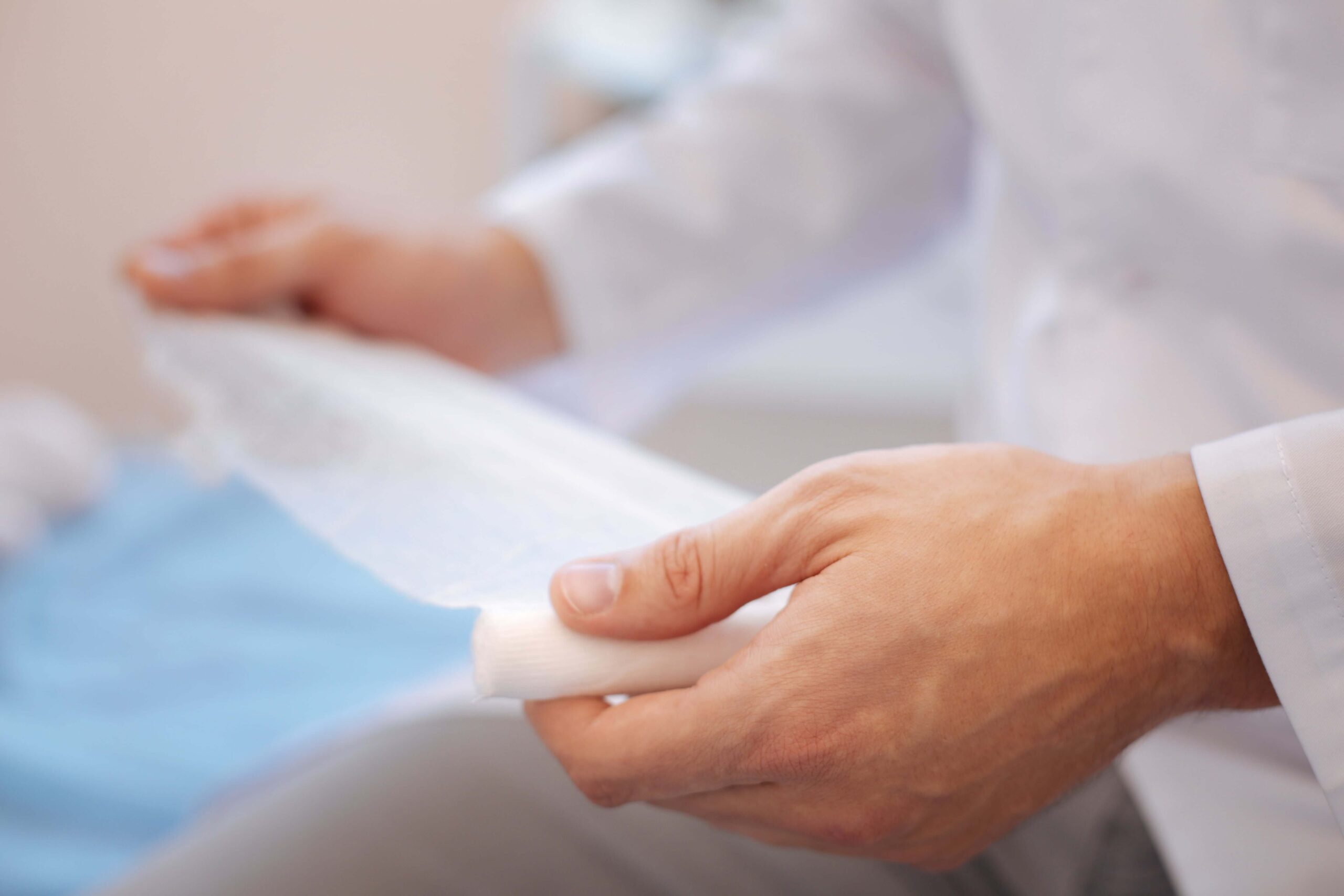 wound care specialist holding a wound dressing